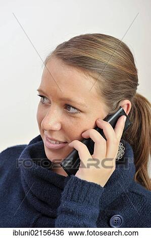 Young woman talking on a telephone View Large Photo Image Stock Photograph - Young woman talking on a telephone. Fotosearch