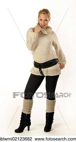 Young woman wearing a knitted sweater and boots View Large Photo Image Stock Image - Young woman wearing a knitted sweater and boots. Fotosearch