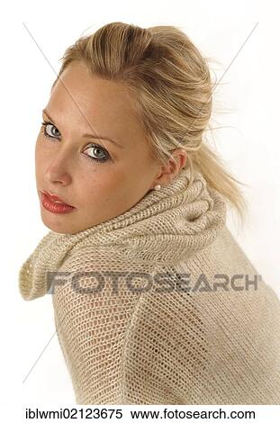 Stock Photography - Young woman wearing a knitted sweater, portrait. Fotosearch