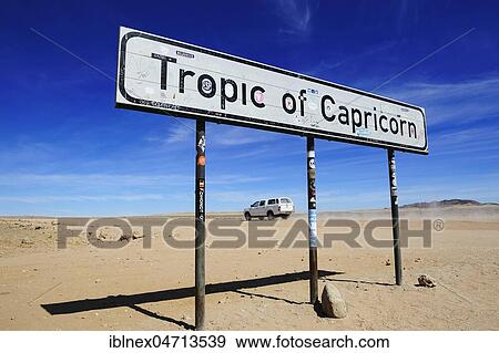 Stock Photo - 4 wheel drive jeep at the Tropic of Capricorn, Namibia, Africa. Fotosearch