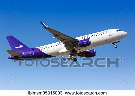 Stock Image - A Wataniya Airways Airbus A320 with registration mark 9K-EAH takes off from Malaga Airport (AGP), Malaga, Spain, Europe. Fotosearch