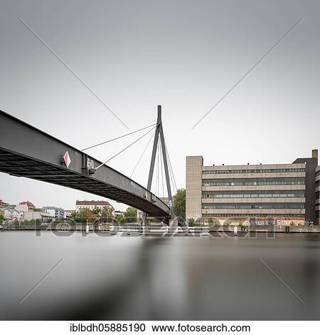 Am Kaisersteg, a pedestrian bridge along the banks of the Spree onto the KWO building in Berlin in the early morning, Germany, Europe View Large Photo Image Stock Image - Am Kaisersteg, a pedestrian bridge along the banks of the Spree onto the KWO building in Berlin in the early morning, Germany, Europe. Fotosearch