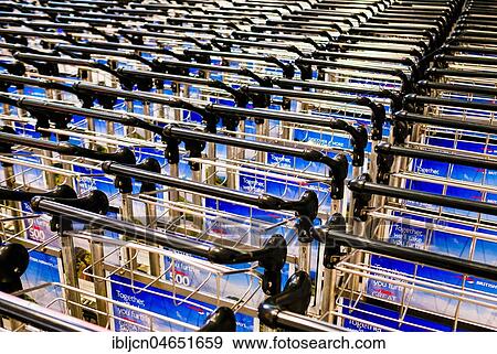 Stock Photo - Baggage carts in line, Heathrow Airport, London, England, Great Britain. Fotosearch