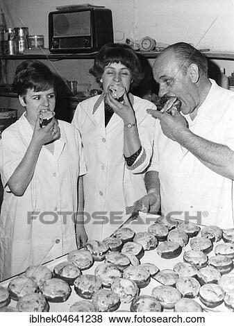 Stock Photo - Baker and employees eat pancakes, doughnuts, Berliner, 1960s, Berlin, Germany, Europe. Fotosearch