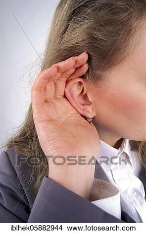 Picture - Blonde woman eavesdropping, Berlin, Germany, Europe. Fotosearch