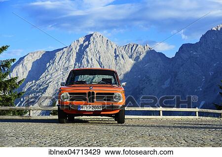 Stock Photo - BMW 2002 tii, classic car on the Rossfeld panorama road, in the back the summit of the Hohe Göll, Berchtesgaden, Upper Bavaria, Bavaria, Germany, Europe. Fotosearch