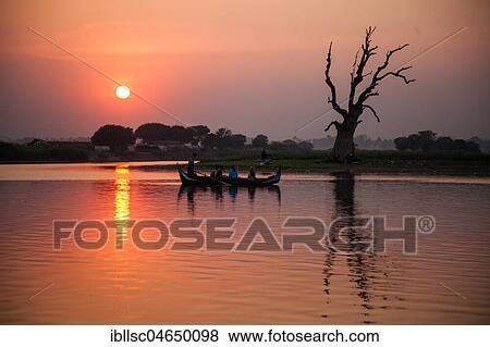 Stock Photo - Boat with sunset on Lake Taungthaman, Amarapura, Myanmar, Asia. Fotosearch