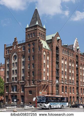 Stock Photography - Brick building in the Speicherstadt next to the Brooktorkai Bridge and RiverBus, Hamburg, Germany, Europe. Fotosearch