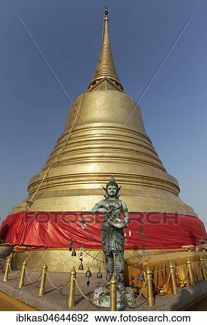 Bronze figure in front of the Golden Chedi on Phu Khao Thong, Golden Mountain in Wat Saket, Pom Prap Sattru Phai District, Bangkok, Thailand, Asia View Large Photo Image Stock Image - Bronze figure in front of the Golden Chedi on Phu Khao Thong, Golden Mountain in Wat Saket, Pom Prap Sattru Phai District, Bangkok, Thailand, Asia. Fotosearch