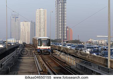 BTS Skytrain passes motorcade, morning traffic jam on Saphan Taksin Bridge, Bangkok, Thailand, Asia View Large Photo Image Stock Photography - BTS Skytrain passes motorcade, morning traffic jam on Saphan Taksin Bridge, Bangkok, Thailand, Asia. Fotosearch