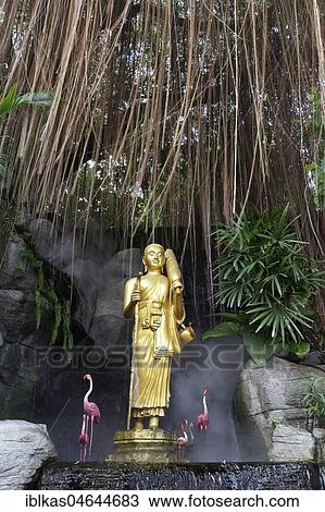 Stock Image - Buddha statue and artificial flamingos, staircase at Phu Khao Thong, Golden Mountain, in What Saket, Pom Prap Sattru Phai district, Bangkok, Thailand, Asia. Fotosearch