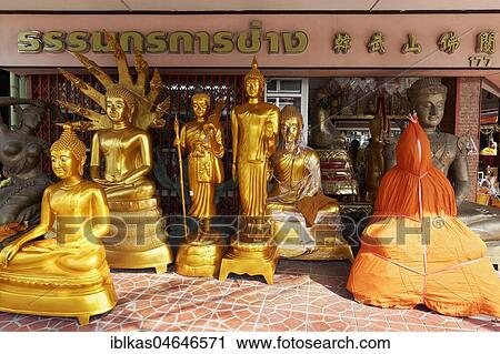 Stock Image - Buddha statues for sale, devotional business in the Buddha Road, Thanon Bamrung Meuang, Phra Nakhon, Bangkok, Thailand.. Fotosearch