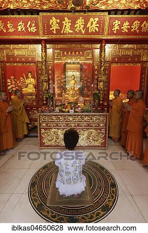 Buddhist Sacrifice Ceremony with praying monks and kneeling woman, Wat Mangkon Kamalawat, Chinese Buddhist temple, Chinatown, Pom Prap Sattru Phai, Bangkok, Thailand, Asia View Large Photo Image Stock Photo - Buddhist Sacrifice Ceremony with praying monks and kneeling woman, Wat Mangkon Kamalawat, Chinese Buddhist temple, Chinatown, Pom Prap Sattru Phai, Bangkok, Thailand, Asia. Fotosearch