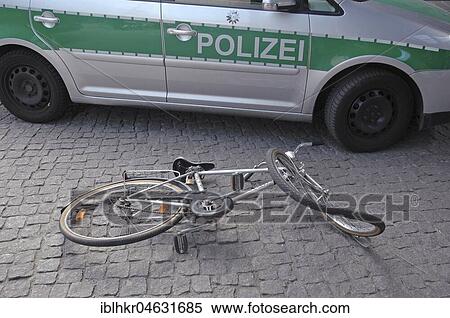 Stock Photography - Bumped bicycle in front of a police car, symbol picture for accident. Fotosearch