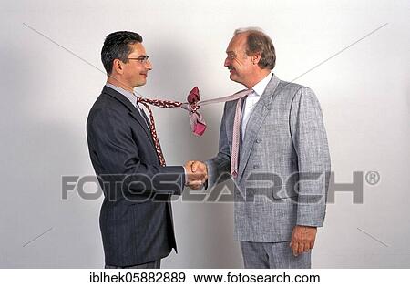 Businessmen shake hands, funny, tie knotted, Berlin, Germany, Europe View Large Photo Image Stock Photo - Businessmen shake hands, funny, tie knotted, Berlin, Germany, Europe. Fotosearch