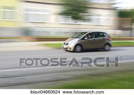 Car minivan drives through residential area, motion blur, Germany, Europe View Large Photo Image Picture - Car minivan drives through residential area, motion blur, Germany, Europe. Fotosearch