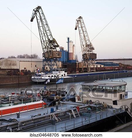 Cargo ships in the canal with cranes in Europe's largest inland port, Duisburg, Ruhr area, North Rhine-Westphalia, Germany, Europe View Large Photo Image Stock Photography - Cargo ships in the canal with cranes in Europe's largest inland port, Duisburg, Ruhr area, North Rhine-Westphalia, Germany, Europe. Fotosearch