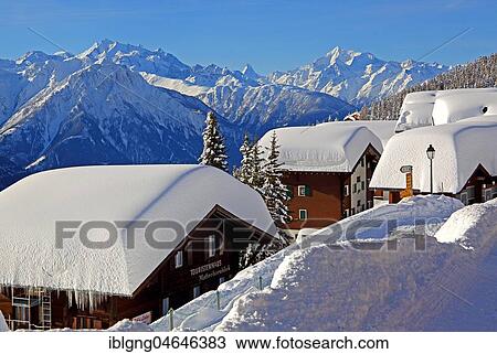 Stock Image - Chalets with deep snow in the village, in the back Dom 4545m, Matterhorn 4478m and Weisshorn 4505m, Bettmeralp, Aletsch area, Upper Valais, Valais, Switzerland, Europe. Fotosearch