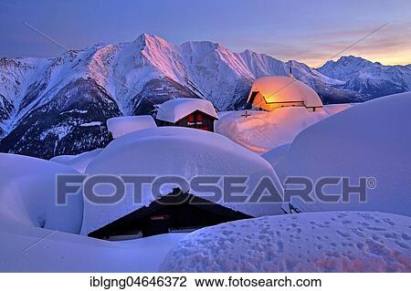 Stock Image - Chapel Maria zum Schnee in the snow in the village centre, in the back Bettlihorn 2993m and Fletschhorn 3985m at dusk, Bettmeralp, Aletsch area, Upper Valais, Valais, Switzerland, Europe. Fotosearch