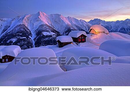 Stock Image - Chapel Maria zum Schnee in the snow in the village centre, in the back Bettlihorn 2993m and Fletschhorn 3985m at dusk, Bettmeralp, Aletsch area, Upper Valais, Valais, Switzerland, Europe. Fotosearch