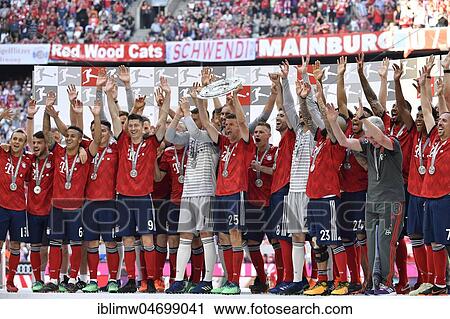 Stock Image - Cheering FC Bayern Munich team after handing over the championship cup, trophy, Allianz Arena, Munich, Bavaria, Germany, Europe. Fotosearch