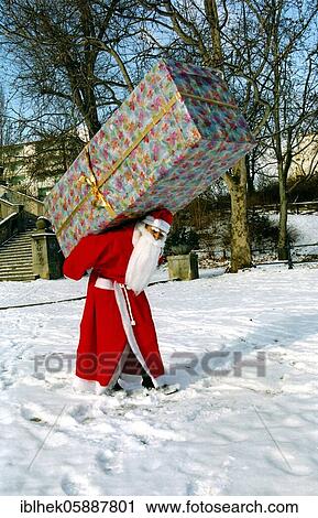 Christmas, Gifts, Santa Claus carries big present, Berlin, Germany, Europe View Large Photo Image Stock Image - Christmas, Gifts, Santa Claus carries big present, Berlin, Germany, Europe. Fotosearch