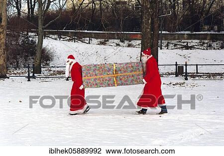 Stock Image - Christmas, Santa Claus, big package, transport, carry, Berlin Germany. Fotosearch