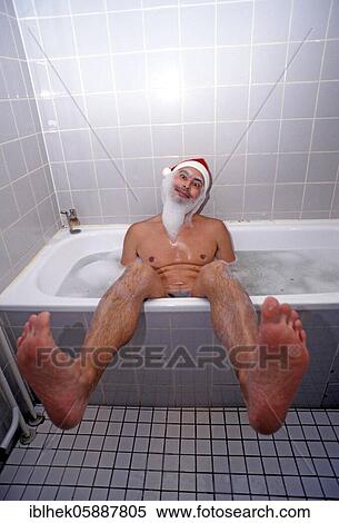 Stock Photography - Christmas, Santa Claus sitting in the bathtub, Bath foam, Berlin, Germany, Europe. Fotosearch