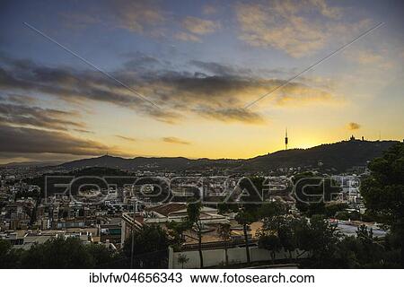 Stock Image - City panorama, city view at sunset, view from Turó de les Tres Creus in Park Güell, Barcelona, Catalonia, Spain, Europe. Fotosearch