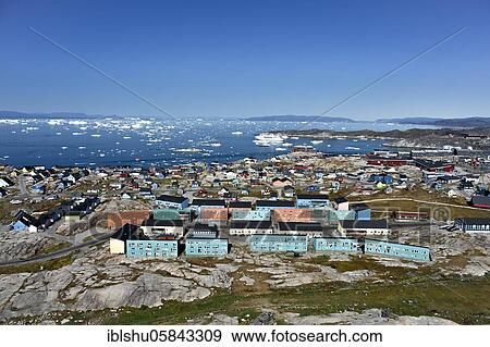 Stock Photo - City view with colourful houses, view into Disko Bay to the cruise ship MS Deutschland, Ilulissat, West Greenland, Greenland, North America. Fotosearch