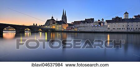 Picture - City view with stone bridge, bridge gate and cathedral, water reflection in the Danube, dawn, Regensburg, Upper Palatinate, Bavaria, Germany, Europe. Fotosearch