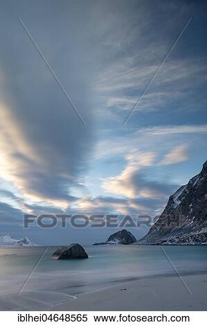 Stock Photography - Cloudy atmosphere on the icy beach of Haukland, Lofoten, Norway, Europe. Fotosearch