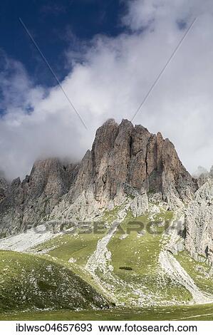 Stock Image - Cloudy Odle group, mountain massif in the Dolomites, Gruppo delle Odle, Puez-Geisler nature park Park, South Tyrolean Alps, Dolomites, South Tyrol. Fotosearch
