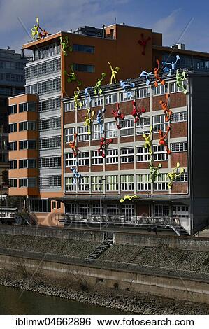 Colourful Flossi figures at the Roggendorf House, Medienhafen, Düsseldorf, North Rhine-Westphalia, Germany, Europe View Large Photo Image Stock Photograph - Colourful Flossi figures at the Roggendorf House, Medienhafen, Düsseldorf, North Rhine-Westphalia, Germany, Europe. Fotosearch