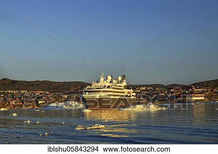 Picture - Colourful houses with a view into Disko Bay to the cruise ship L'Austral, Ilulissat, West Greenland, Greenland, North America. Fotosearch