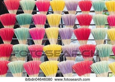 Stock Image - Colourful incense sticks for sale, Hue, Vietnam, Asia. Fotosearch