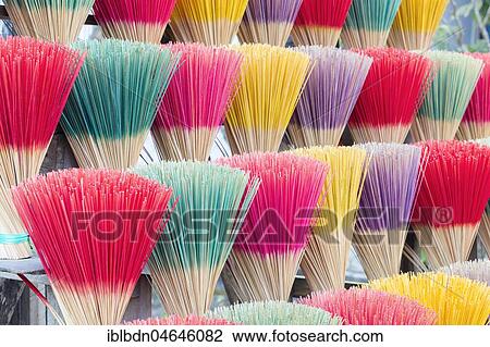 Stock Image - Colourful incense sticks for sale, Hue, Vietnam, Asia. Fotosearch