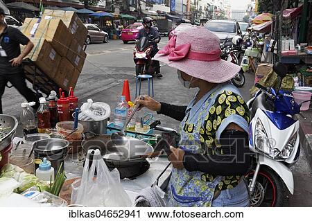 Cookshop, woman cooking at a streetfood stand, Yaowarat Road, Chinatown, Samphanthawong, Bangkok, Thailand, Asia View Large Photo Image Stock Image - Cookshop, woman cooking at a streetfood stand, Yaowarat Road, Chinatown, Samphanthawong, Bangkok, Thailand, Asia. Fotosearch