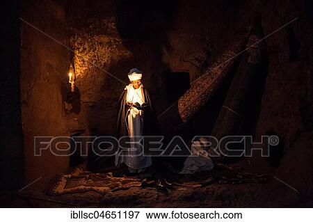 Coptic priest by candlelight in Rock Church, Lalibela, Ethiopia, Africa View Large Photo Image Stock Photo - Coptic priest by candlelight in Rock Church, Lalibela, Ethiopia, Africa. Fotosearch