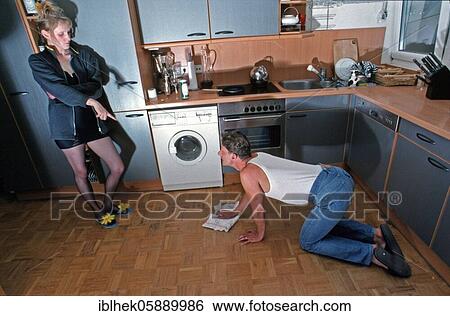 Stock Photograph - Couple, Relationship, Man cleans, Woman commands, Berlin, Germany, Europe. Fotosearch