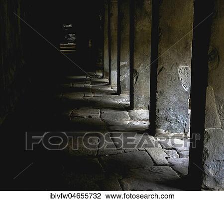 Stock Image - Dark Arcade in Khmer Temple Ruin, Temple complex, Ta Prohm Temple, Angkor Wat, Angkor Archaeological Park, Siem Reap Province, Cambodia, Asia. Fotosearch