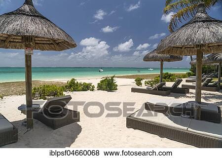Stock Photo - Deck chairs on the beach of Pointe d'Esny, Mahebourg, Grand Port, Mauritius, Africa. Fotosearch
