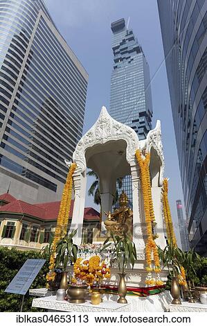 Decorated Hindu shrine with golden Brahma statue in front of luxury hotel W Bangkok, view of Maha Nakhon Building, Bang Rak, Bangkok, Thailand, Asia View Large Photo Image Stock Image - Decorated Hindu shrine with golden Brahma statue in front of luxury hotel W Bangkok, view of Maha Nakhon Building, Bang Rak, Bangkok, Thailand, Asia. Fotosearch