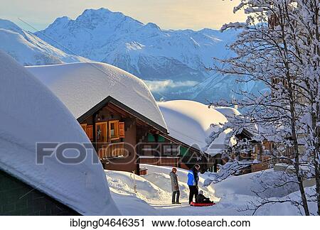 Stock Image - Deep snowy chalets, in the back Fletschhorn 3985m, Bettmeralp, Aletsch area, Upper Valais, Valais, Switzerland, Europe. Fotosearch