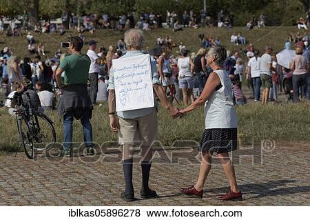Stock Photo - Demo against corona rules on the Rhine meadows, senior citizens' couples with poster for corona vaccination, Düsseldorf, North Rhine-Westphalia, Germany, Europe. Fotosearch