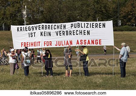 Stock Photograph - Demo against corona rules on the Rhine meadows, Transparent freedom for Julian Assange, Düsseldorf, North Rhine-Westphalia, Germany, Europe. Fotosearch