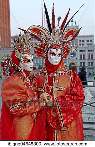 Stock Image - Disguised couple with Venetian masks in front of Bridge of Sighs, Carnival in Venice, Italy, Europe. Fotosearch