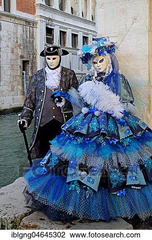 Stock Image - Disguised couple with Venetian masks in front of Bridge of Sighs, Carnival in Venice, Italy, Europe. Fotosearch