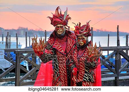 Stock Image - Disguised couple with Venetian masks on the lagoon, carnival in Venice, Italy, Europe. Fotosearch