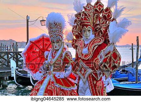 Stock Photography - Disguised couple with Venetian masks on the lagoon, carnival in Venice, Italy, Europe. Fotosearch